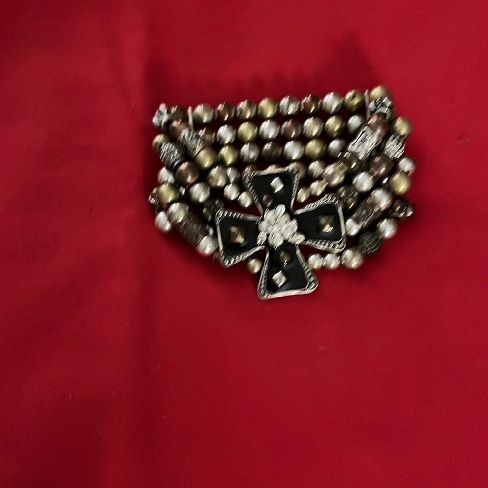 Jewelry. Large black cross with four rows of assorted beads bracelet.